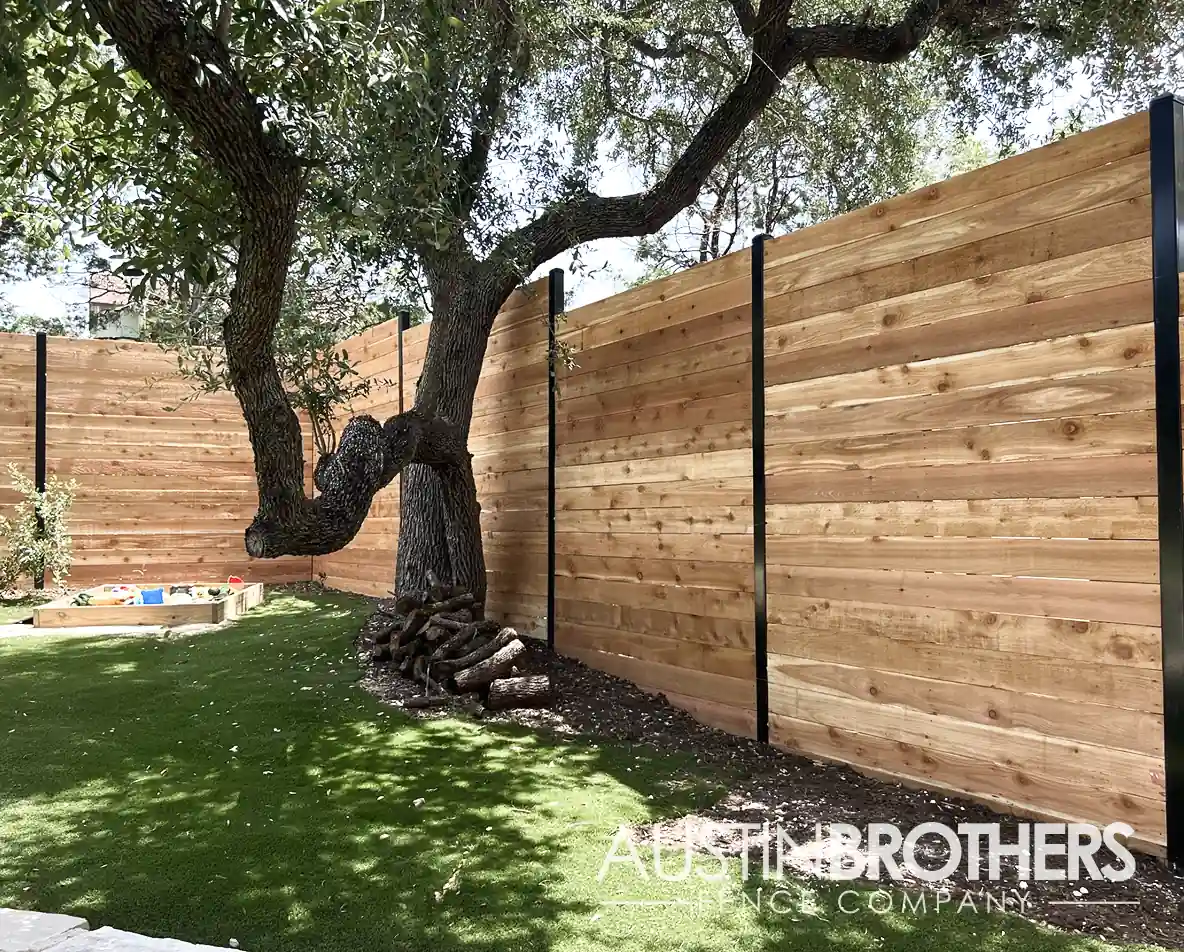 Horizontal wooden fence with black steel posts.