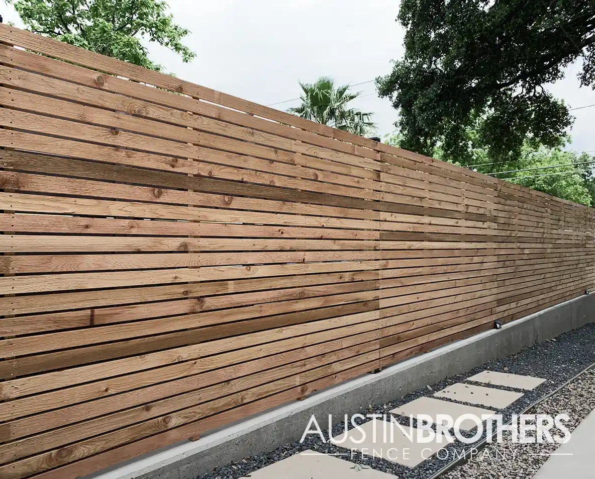 Horizontal wooden fence with cedar boards and mid support.