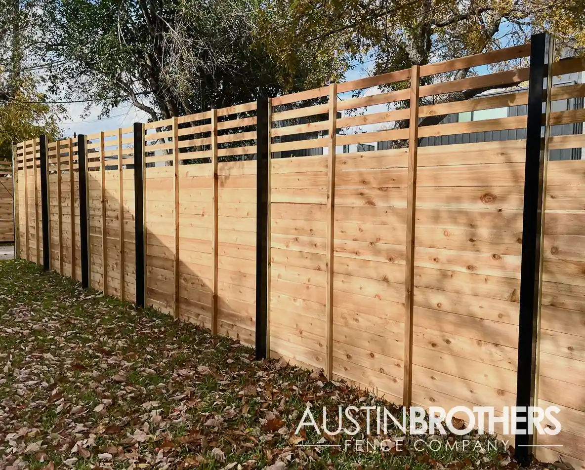 Horizontal wooden fence with square steel posts.