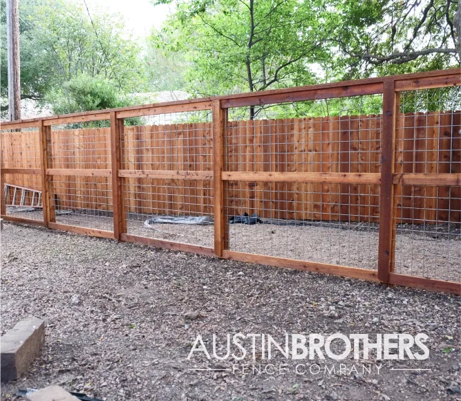 Wooden bull panel fence with reinforcements at the middle.