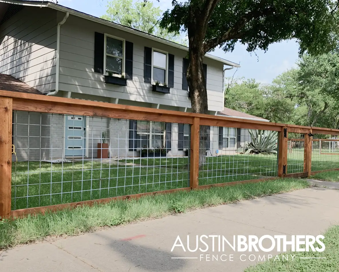 Wooden bull panel fence running along the front yard of an Austin, Texas home.