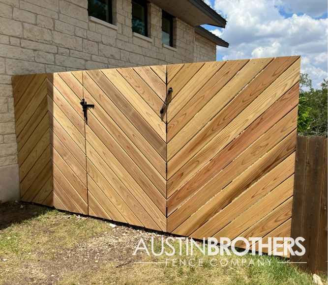 Angled wooden fence with a gate and latch.