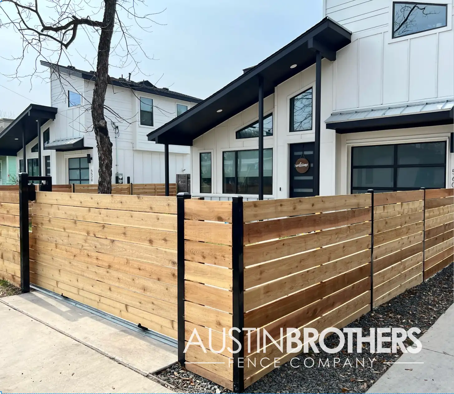 Horizontal wooden fence with reinforced black steel posts.