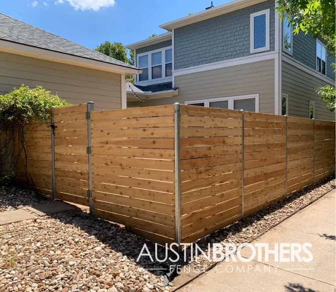 Horizontal wooden fence with iron posts.