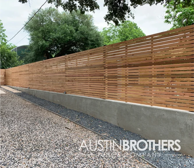 Horizontal wooden fence with reinforced posts.
