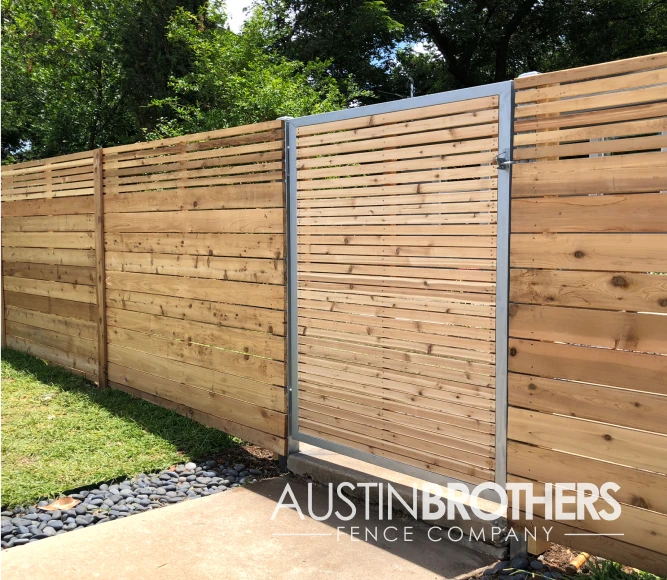 Horizontal wooden fence and a wooden gate with a steel frame.