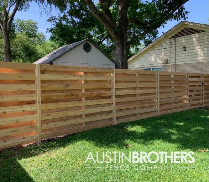 Horizontal wooden fence with wooden posts.
