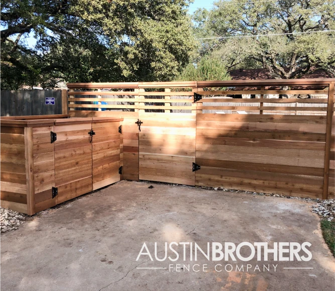 Horizontal wooden fence with two steel gates and latches.