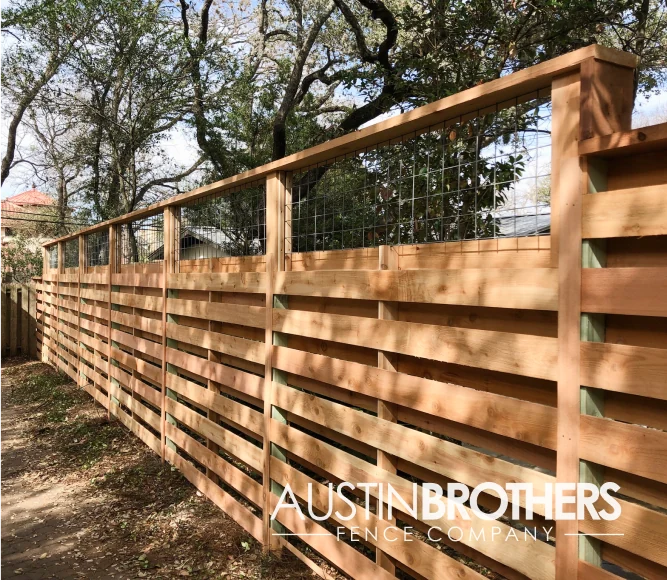Horizontal wooden fence with capped bull panel on top.