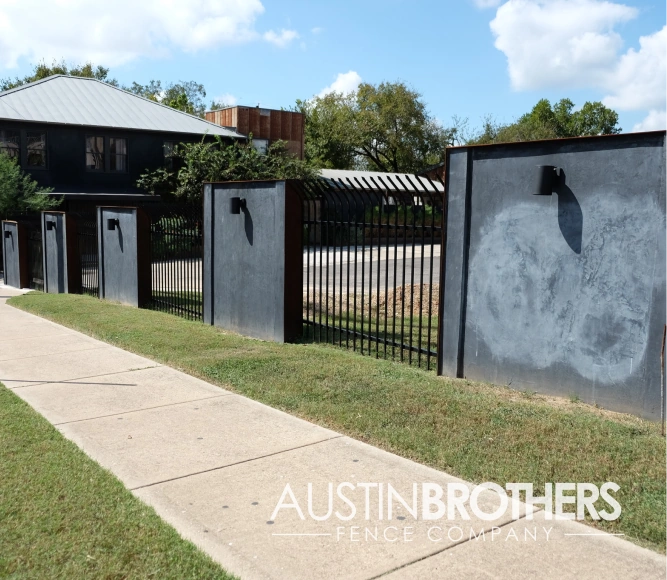 Iron fence between steel walls.