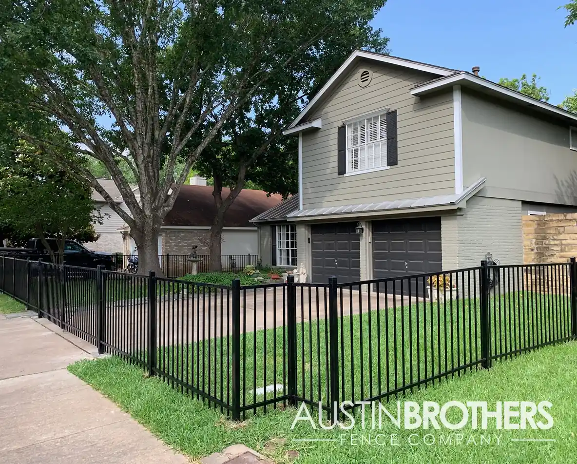 Waist-high black iron fence in front of an Austin, Texas home.