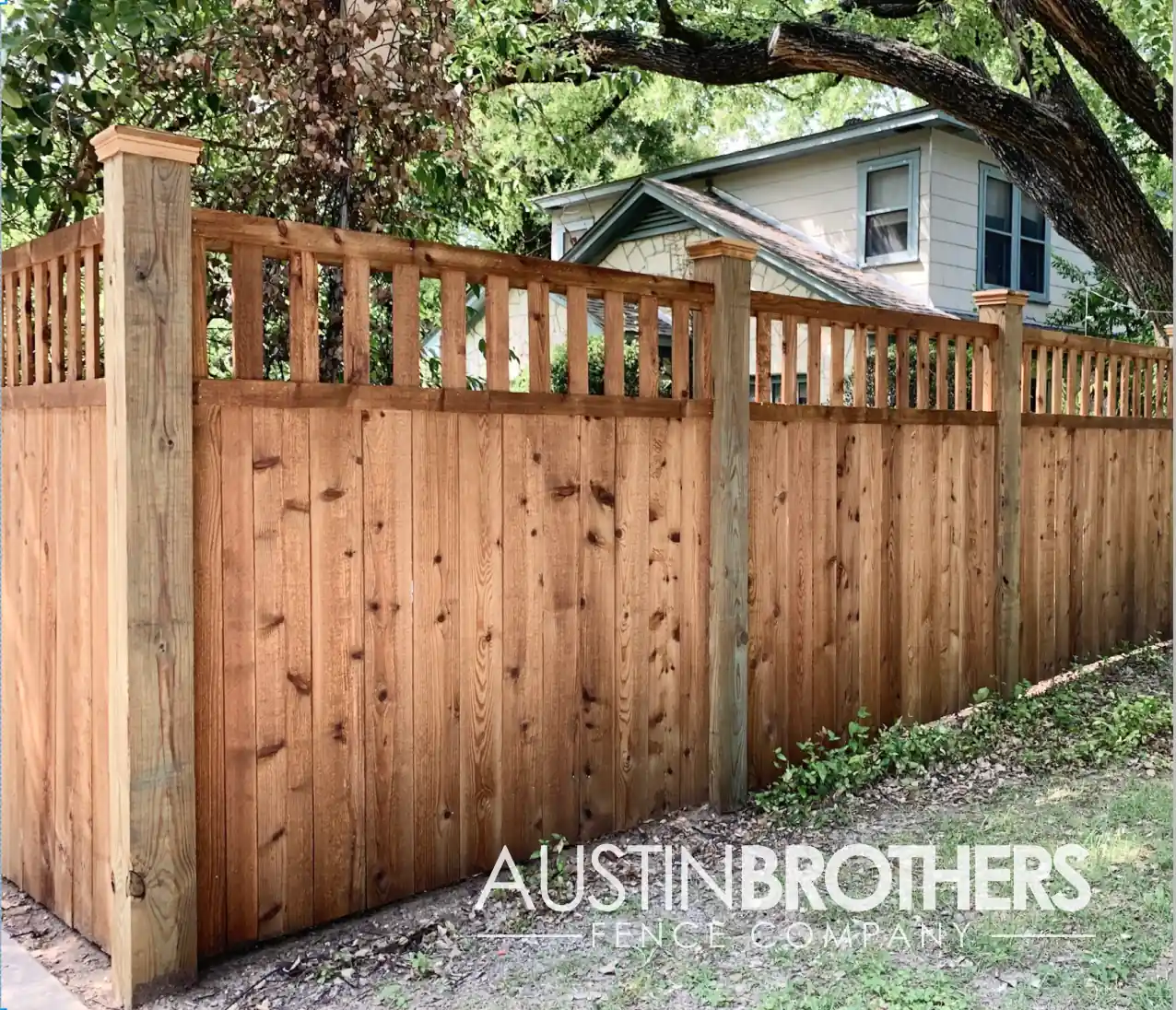 Vertical wooden fence with reinforced capped wooden posts.