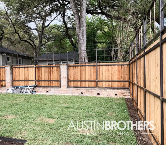Vertical wooden fence with iron reinforcements.