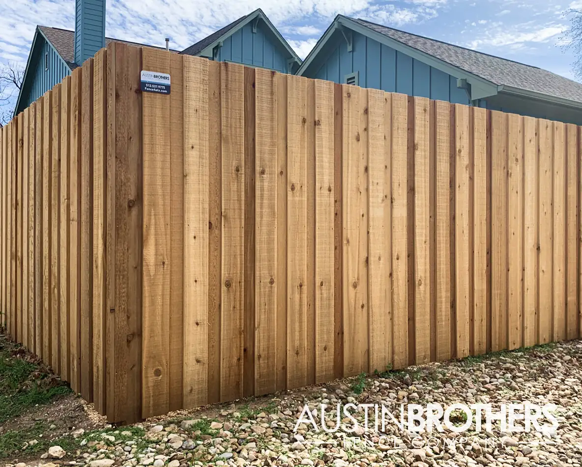 Wooden vertical fence cornering off an Austin, Texas backyard.