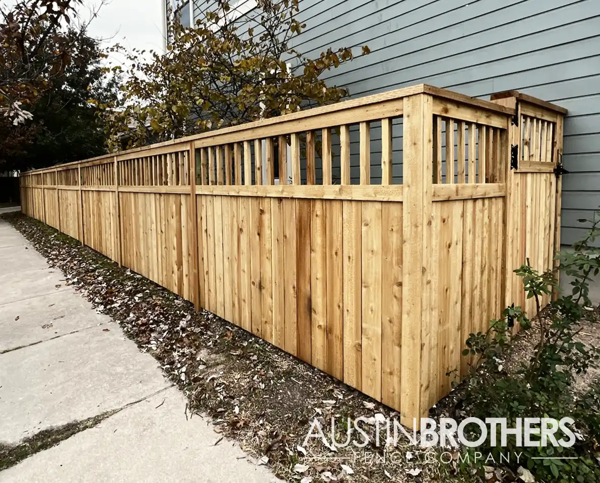 Capped vertical wooden fence on the side yard of a Central Texas home.