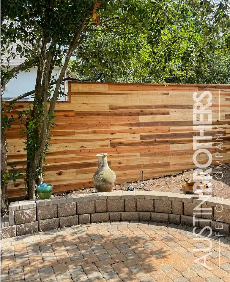 Horizontal wooden fence in the back yard of an Austin, Texas home.