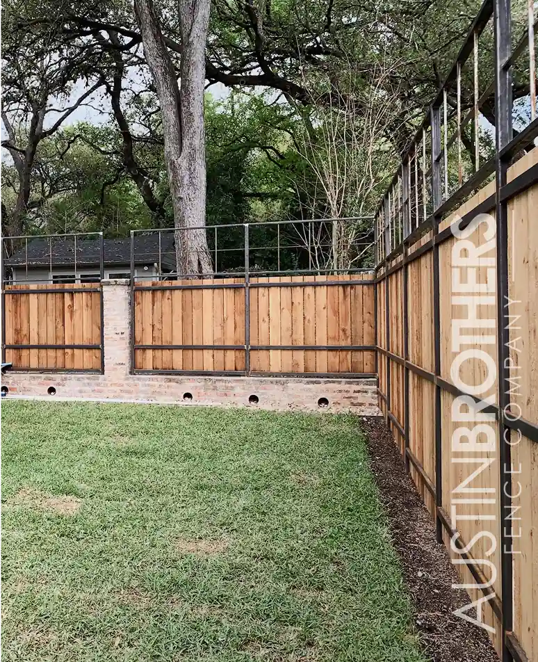 Vertical wooden fence with black steel posts and horizontal reinforcements.